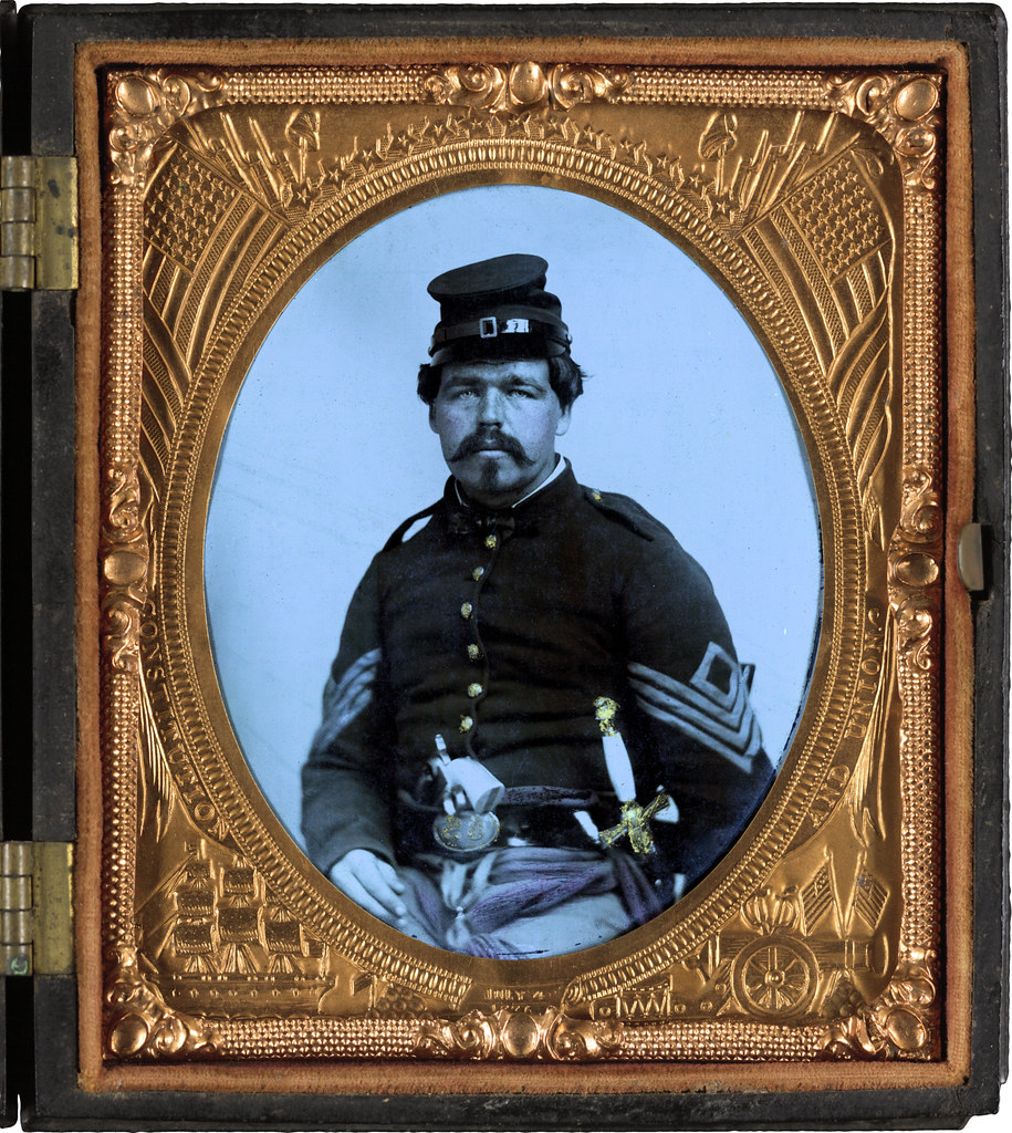 Unidentified soldier in Union first sergeant's uniform with militia sword and revolver