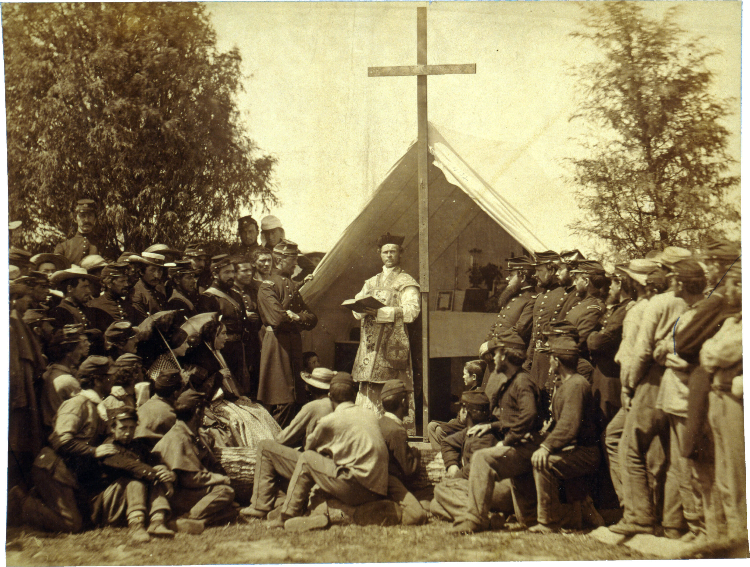Photograph shows Father Thomas H. Mooney, Chaplain of the 69th Infantry Regiment of the New York State Militia and Irish American soldiers at a Catholic Mass at Fort Cocoran, Arlington Heights, Virginia on June 1, 1861. (Source: The Irish American, June 22, 1861)